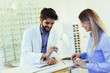 © Mediteraneo - Woman choosing her new glasses at optics store with help of ophthalmologist