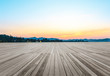 Empty wooden floor and hill silhouette at sunset