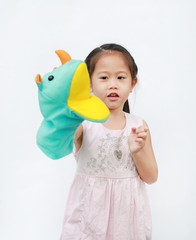 Wall Mural - Adorable little Asian child girl hand wear and playing Rhinoceros puppets on white background.