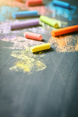 Colorful crayons on the blackboard, drawing. Back to school background.