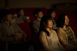 © amanaimages - 映画を見る2人の女性
