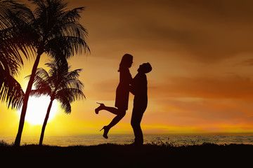 Wall Mural - Silhouette of romantic couple in love with sunset view