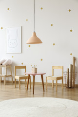 Wall Mural - White round rug in bright child's room interior with lamp above table and wooden chairs. Real photo