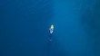 Aerial view of young man riding paddleboard