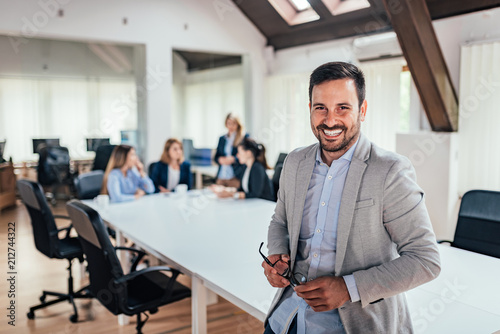 Cuadros en Lienzo Portrait of successful entrepreneur, colleagues working in the background