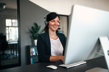 Canvas Print - Female customer service representative using headset.