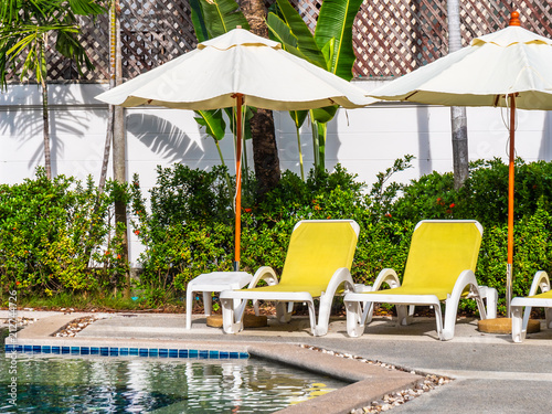 Umbrella And Chair Around Luxury Outdoor Swimming Pool