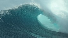 SLOW MOTION, CLOSE UP: Glassy Droplets Of Ocean Water Fly Away From Spectacular Tube Wave Crashing Near A Tropical Beach In Teahupoo, Tahiti. Perfect Barrel Wave Breaks And Splashes Into The Blue Sky.