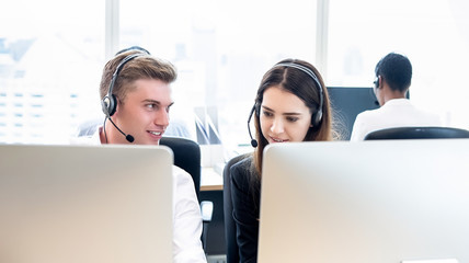 Wall Mural - Businessman telemarketing staff working with coworker in call center office