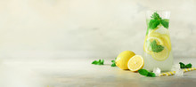 Detox Water With Mint, Lemon On Grey Background. Banner With Copy Space. Citrus Lemonade. Summer Fruit Infused Water. Refreshing Homemade Cocktail, Selective Focus.