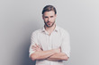 © deagreez - Glance people person ceo career director executive inspector inspection auditor respect concept. Portrait of  proud confident banker standing with crossed hands isolated on gray background copyspace