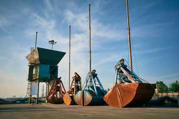 Wall Mural - Grabber for bulk cargo laying on pier ship bulk terminal. Cargo transportation concept.