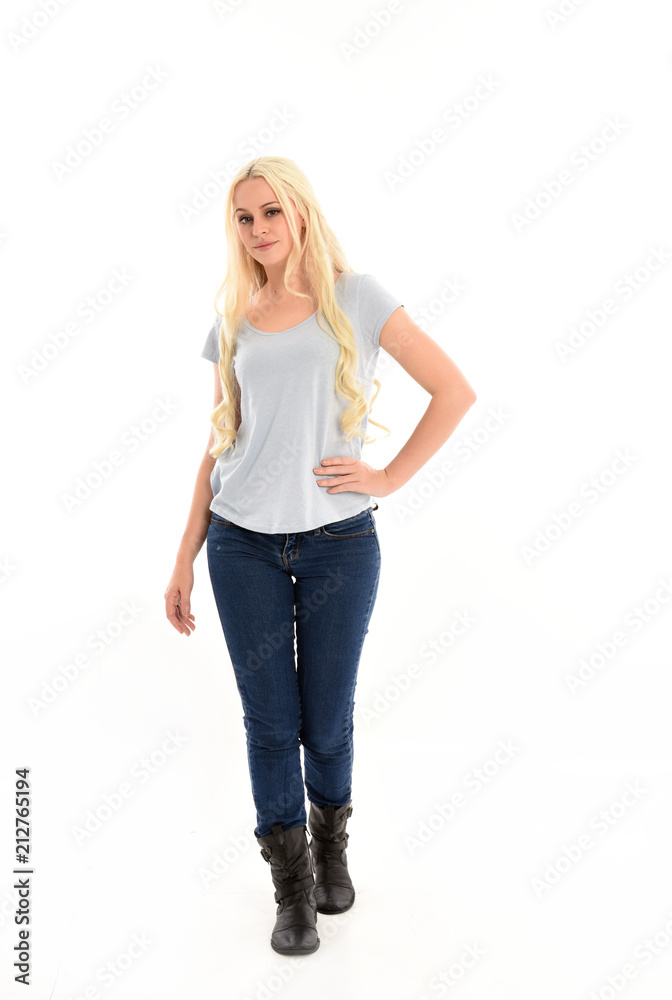 full length portrait of blonde girl wearing blue shirt and jeans ...