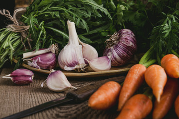 Wall Mural - Fresh organic autumnal vegetables, garlic, arugula  and carrots