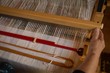 © Wavebreak Media - Senior woman weaving silk at shop