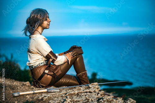 Foto Fantasy cosplay beautiful Witcher girl on cliff