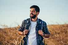 Happy Young Man Hiking With Backpack