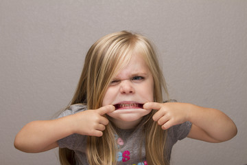 girl making funny faces to the camera