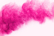 Abstract pink powder splatted on white background,Freeze motion of color powder exploding/throwing color powder, colored glitter texture.