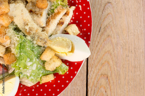 Fotografía Bowl of Caesar Salad on the wooden table.