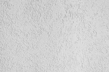 texture of the surface of the wall covered with decorative plaster of the woodworm type