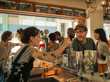 © mavoimages - Smiling patron ordering drinks in a trendy bar