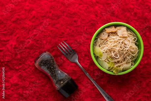 Fotografía Noodles in green cups placed on red wool.