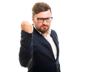 Wall Mural - Portrait of angry business man showing fist gesture.