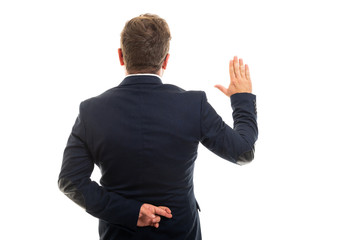 Wall Mural - Back view of business man showing fake oath gesture.