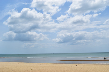 Beach with sea smooth and Cumulus cloud on beautiful blue sky , Fluffy clouds formations at tropical zone , Holiday activities on the sand , Thailand
