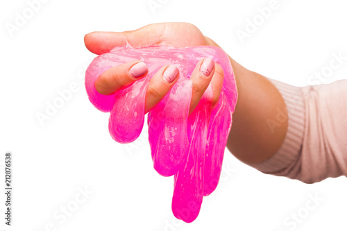 Fotomural a toy for children mucus and liquid flowing on hand on a white background