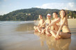 © kichigin19 - group of friends, youth sitting sunbathing on the beach / summer friends relaxing on the sea, vacation with friends on the coast tourism