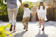 © Blue Jean Images - Happy young Chinese family holding hands running