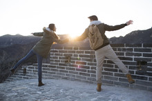 Happy Young Chinese Couple Enjoying Winter Outing On The Great Wall