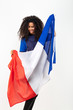 Portrait d'une jeune supportrice de l'équipe de France de football portant un chapeau , des lunettes tricolore et une écharpe de son équipe	