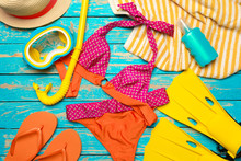 Composition With Swimsuit On Color Wooden Background