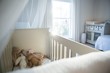 © Wavebreak Media - Wooden cradle with soft toys at home