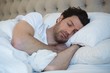© Wavebreak Media - Man sleeping in bedroom