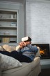 © Wavebreak Media - Man using virtual reality headset in living room