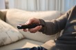 © Wavebreak Media - Man changing channel with remote control at home