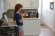 © Wavebreak Media - Woman having coffee in kitchen at home