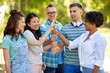 © Syda Productions - success, friendship and international concept - group of happy smiling friends making thumbs up gesture in park