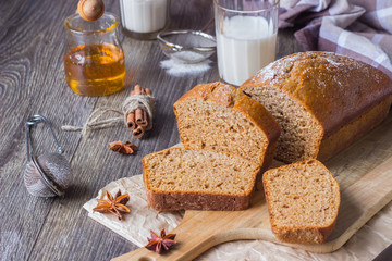 Spicy honey cake with sugar powder served on rustic background. Honey cake for Rosh Hashanah.