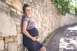 © Louis-Photo - Portrait of a happy and proud pregnant woman on urban background