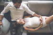 © Louis-Photo - Young happy Couple expecting baby on sofa