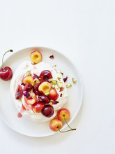 Cherry And Pistachio Meringue On White Plate