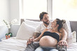 © Louis-Photo - Man with pregnant woman in bed at home having great time