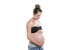 © Louis-Photo - pregnant woman caressing her belly over white background