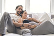 © Louis-Photo - Man with pregnant woman in bed at home having great time