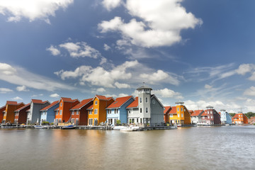 Fototapete - colorful buildings on water over blue sky